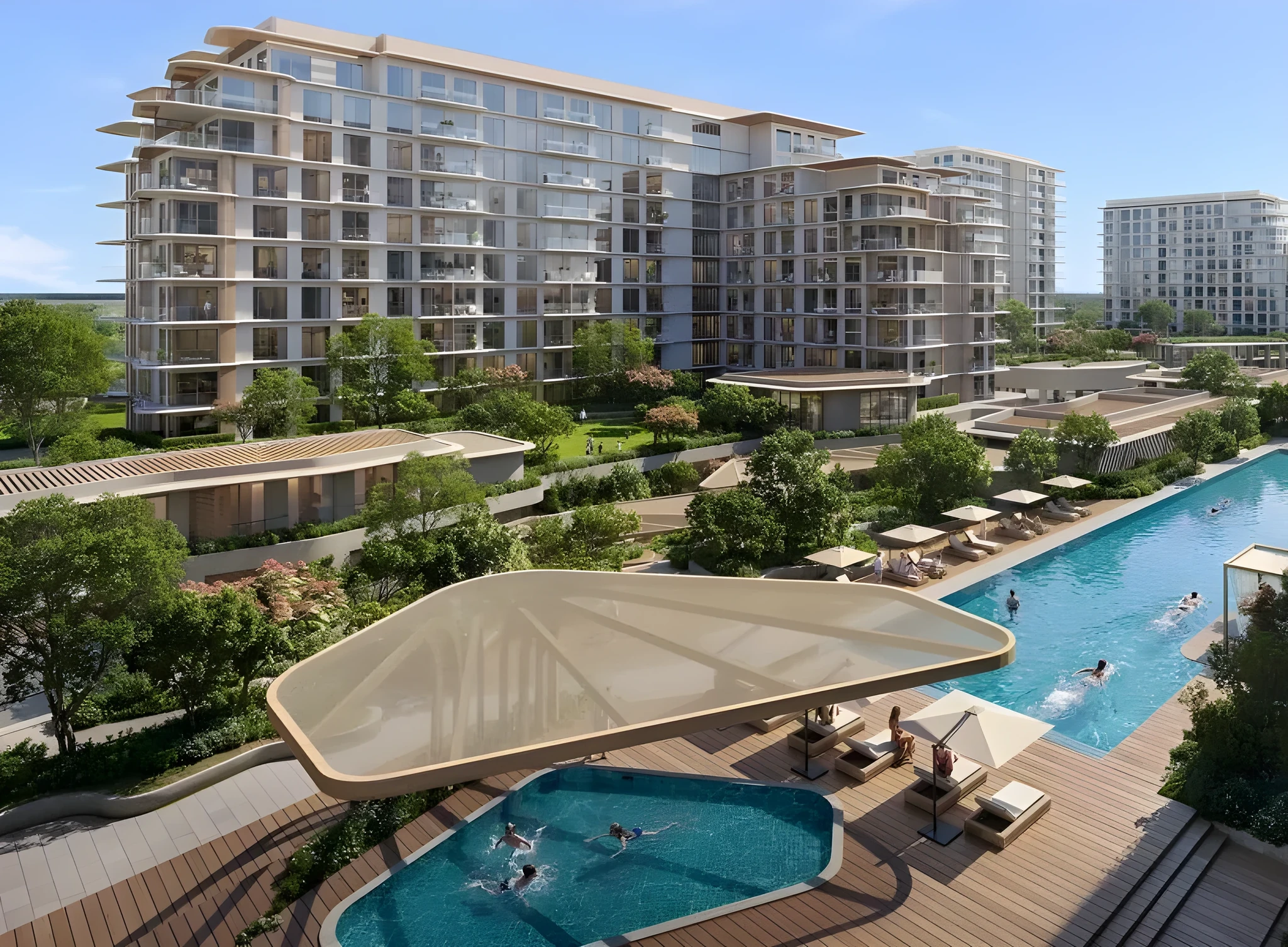 Aerial view of a resort-style swimming pool with a large curved canopy, wooden decking, sun loungers with umbrellas, and swimmers, set beside multi-story glass-fronted apartment buildings and green landscaping under a clear sky.