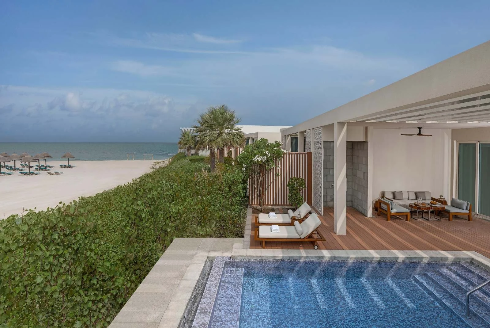 InterContinental Ras Al Khaimah Mina Al Arab Resort & Spa, an IHG Hotel, Mina Al Arab, Ras Al Khaimah: Private beachfront villa featuring a mosaic-tiled pool, two cushioned loungers on a wooden deck, a covered seating area with a ceiling fan, and a